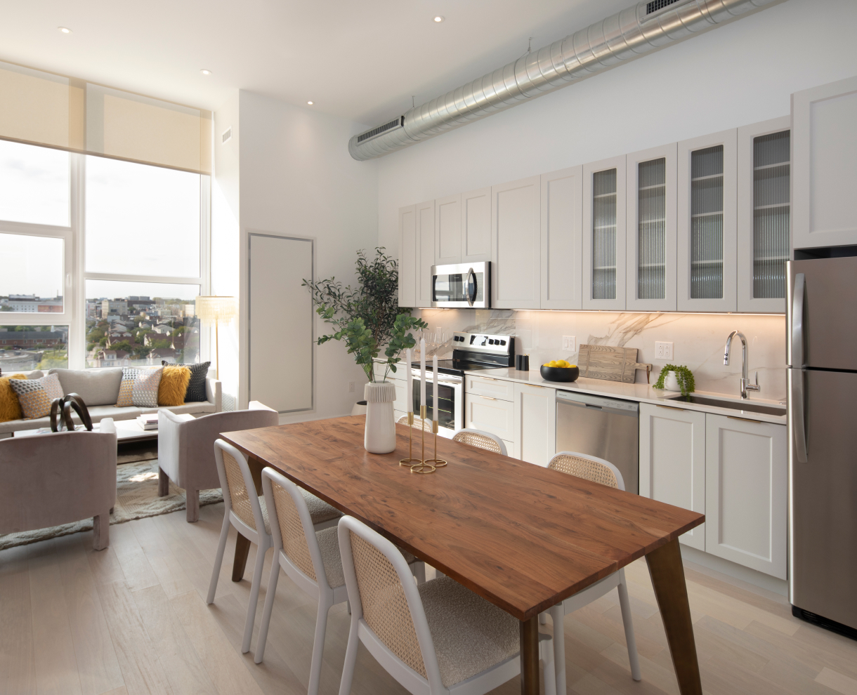 Apartment white-tone interior with kitchen and living room view