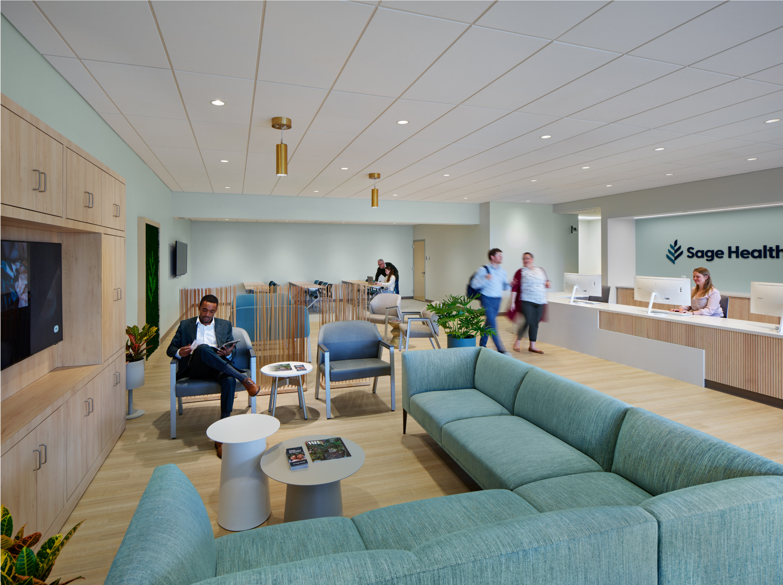 Sage Health waiting area with sofa and tv in front of the front desk