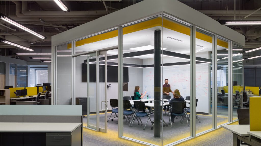 People are having a conference in a office cube