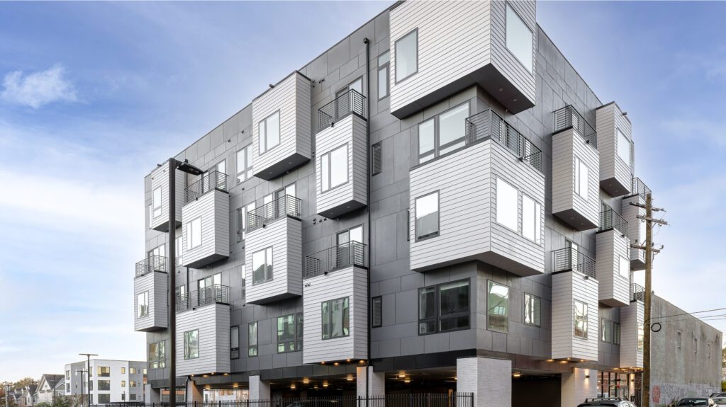 Multi-unit apartment exterior with some extruded windows/balconies