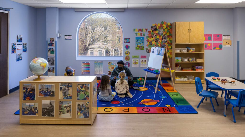 Kids are listening to the teacher at a daycare center