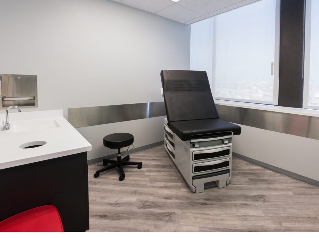 AbsoluteCARE exam room with a exam bed and a sink