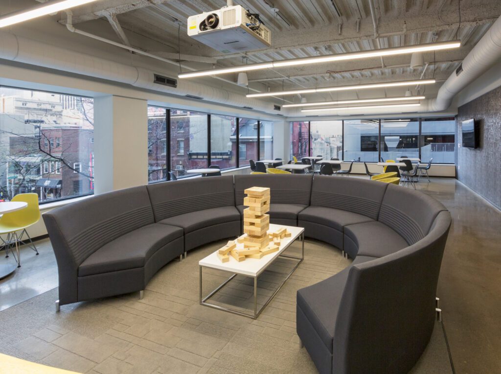 Security Risk Advisor lounge with a round sofa and a table with jenga blocks