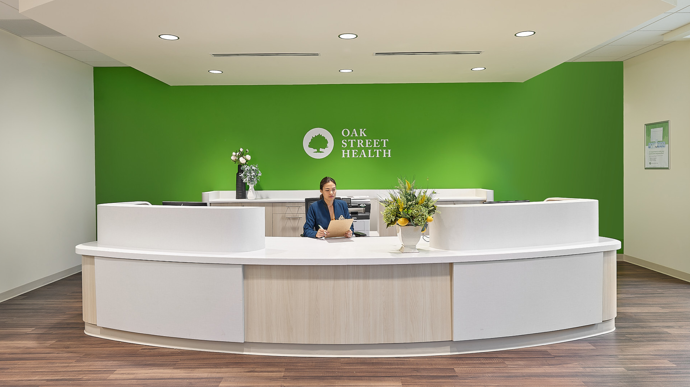 A woman is sitting at a front desk of OSH
