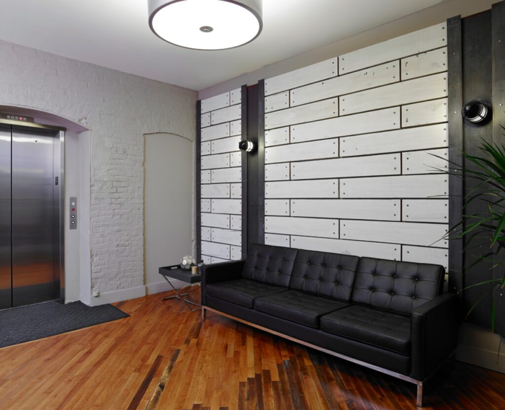 Chamber Lofts sitting area with an elevator and a sofa