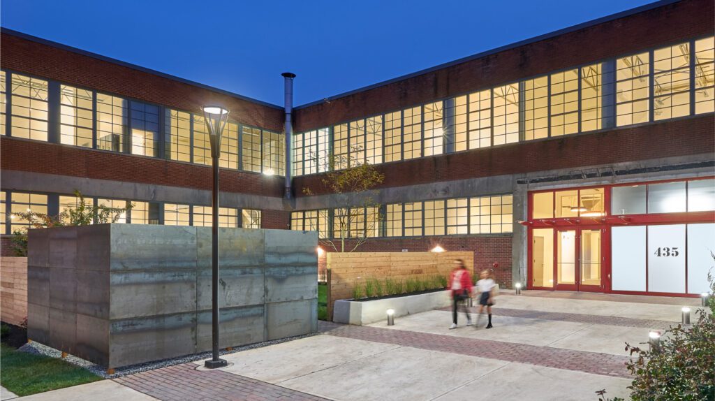 Culbertson Apartments entrance in the evening with two people coming out