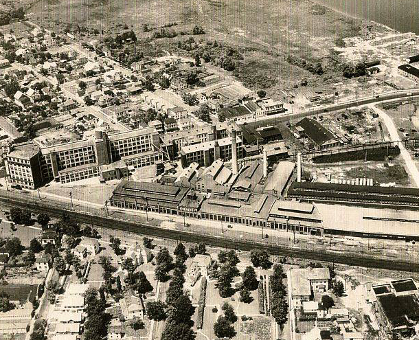 an aerial historical photo of Riverside, NJ. the Keystone Watch Case Company building stands tall over the rest of the town, while a number of no longer existing factories are shown to be nearby.