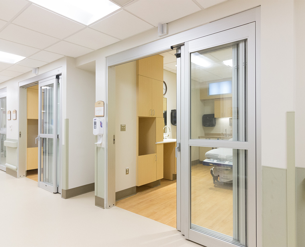 hallway with views into patient rooms