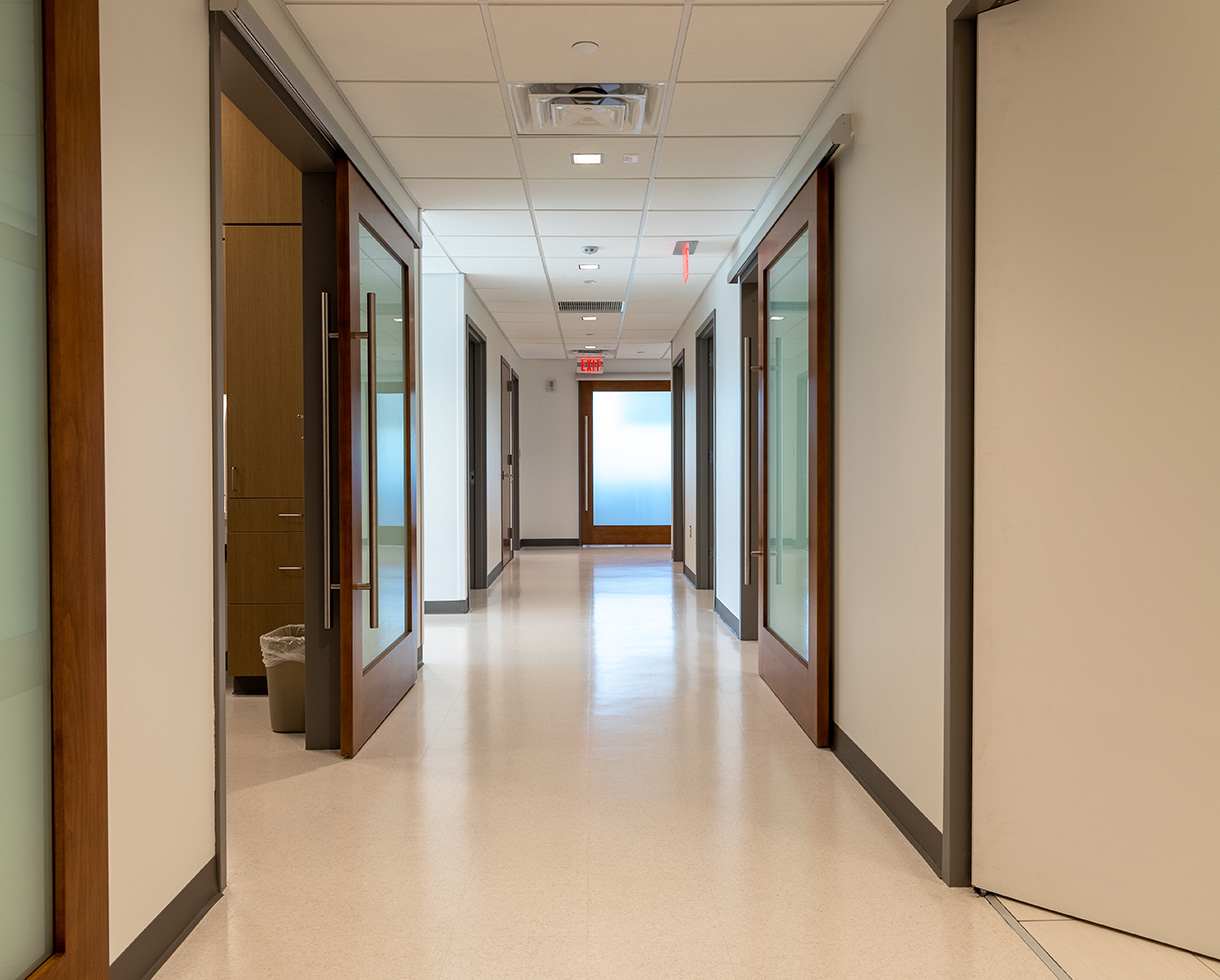 hallway with sliding doors to exam rooms