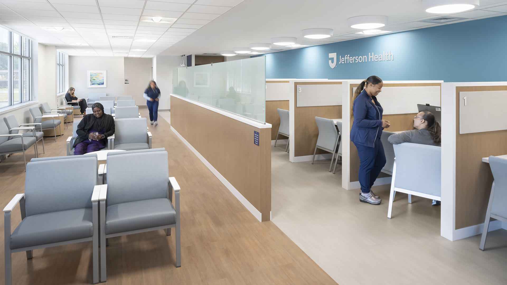 photo of the reception and waiting area, showcasing visitors and nurses flowing through the space